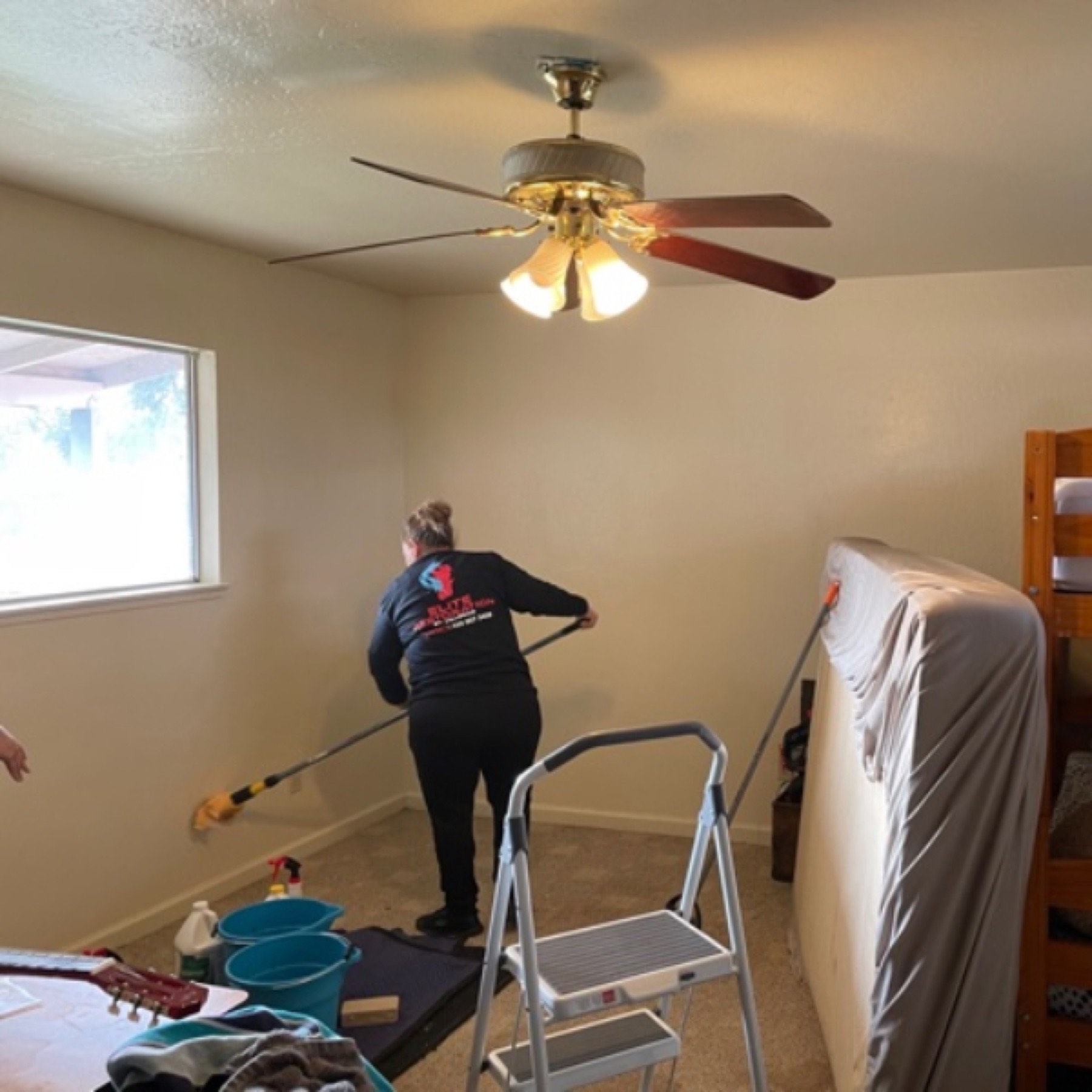 Technician inspecting ceiling for damage